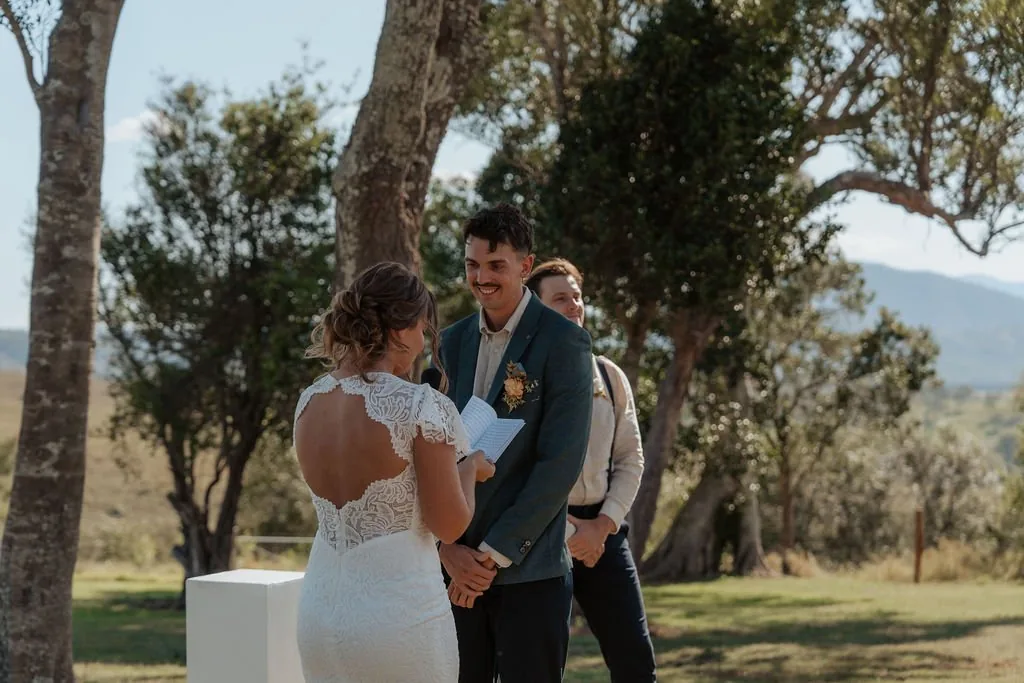 Nicola and Aaron laughing together during their wedding ceremony